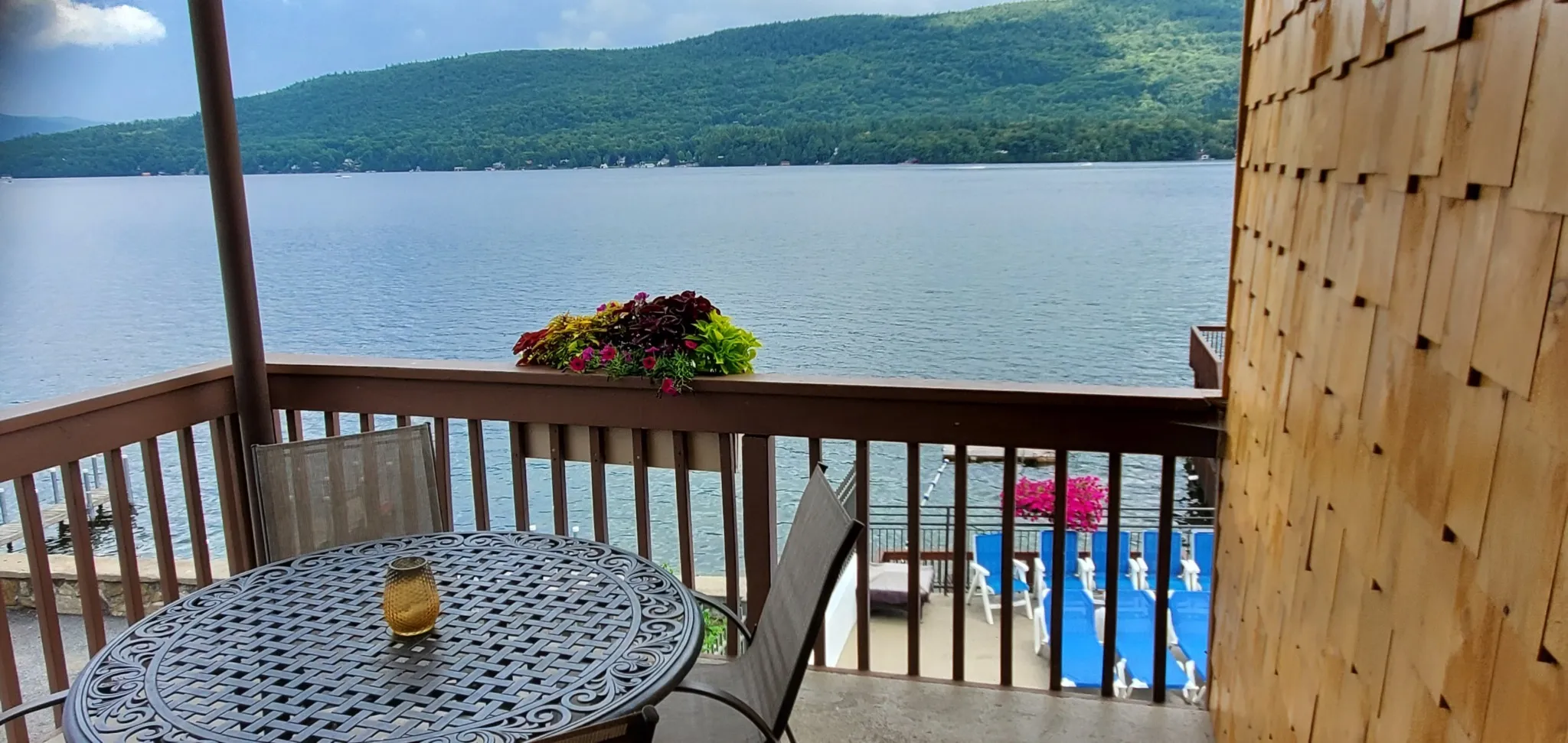 patio with table and chairs overlooking lake